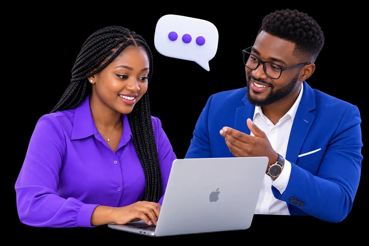 A mentor and a mentee reviewing work together on a laptop